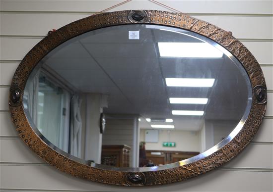 An Arts & Crafts style copper frame mirror, W.98cm